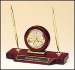 BC854 Desk clock with double pen set on piano-finish rosewood base; diamond-spun dial, 3-hand movement.